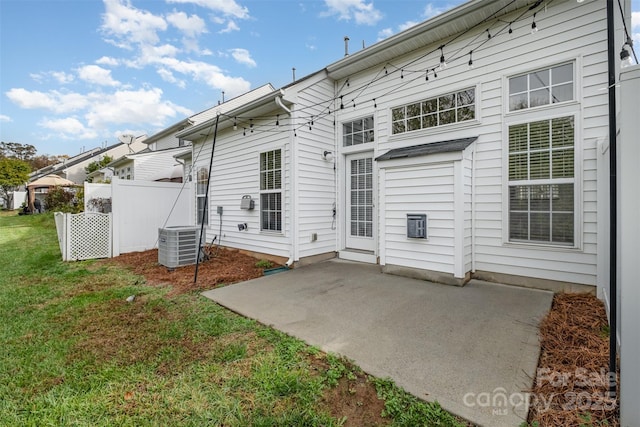 rear view of property with a patio, a yard, and cooling unit