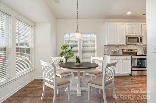 dining area with dark hardwood / wood-style flooring