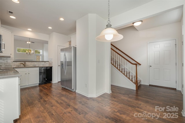 kitchen with white cabinetry, stainless steel fridge, black dishwasher, and decorative light fixtures