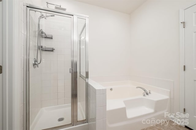 bathroom featuring separate shower and tub