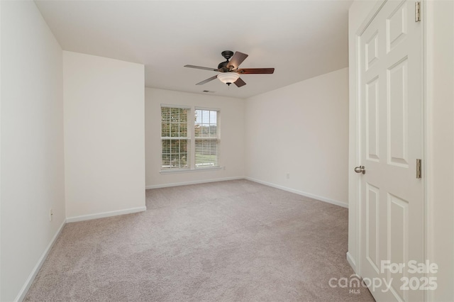 empty room featuring light colored carpet and ceiling fan