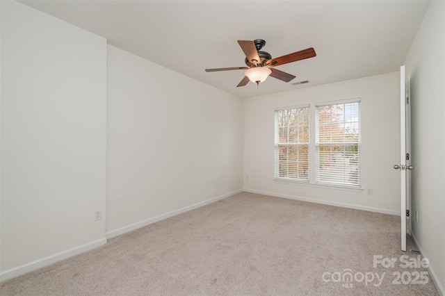 carpeted spare room with ceiling fan