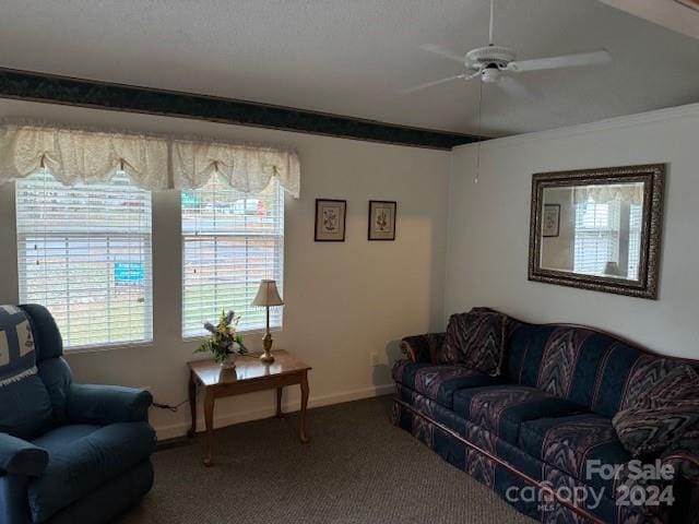 carpeted living room featuring crown molding and ceiling fan