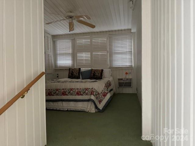 bedroom featuring carpet, a wall mounted AC, and ceiling fan