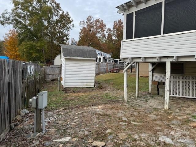 view of yard with a storage shed and a sunroom