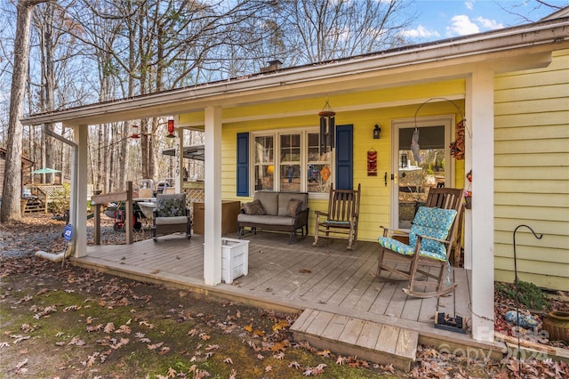 wooden terrace featuring covered porch