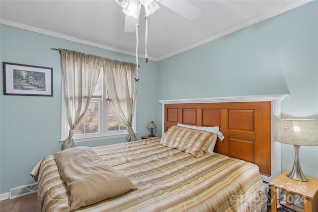 bedroom with a textured ceiling, hardwood / wood-style flooring, ceiling fan, and crown molding