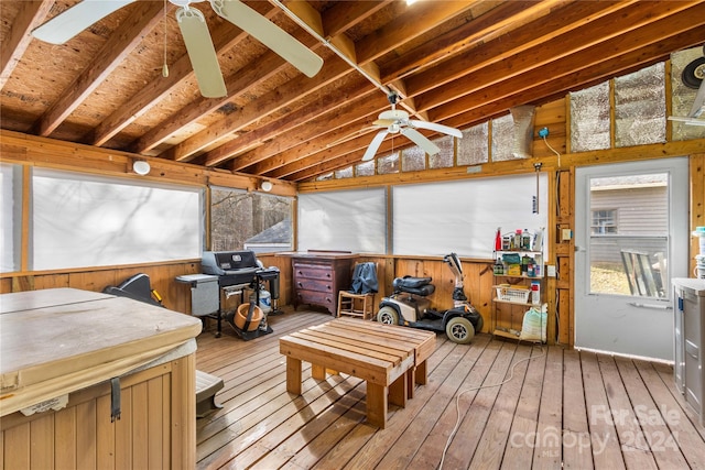 sunroom / solarium with ceiling fan and vaulted ceiling