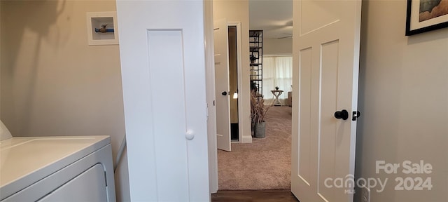 laundry room featuring washer / dryer and dark carpet