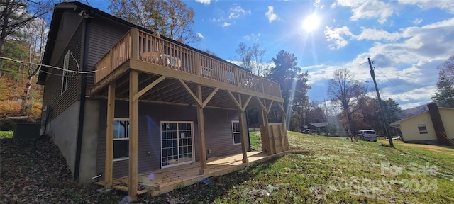 view of property exterior featuring a yard and a deck