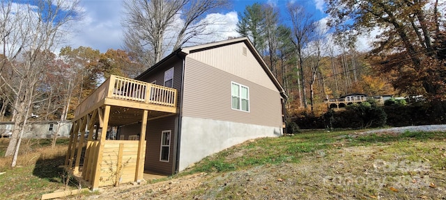 view of property exterior with a deck