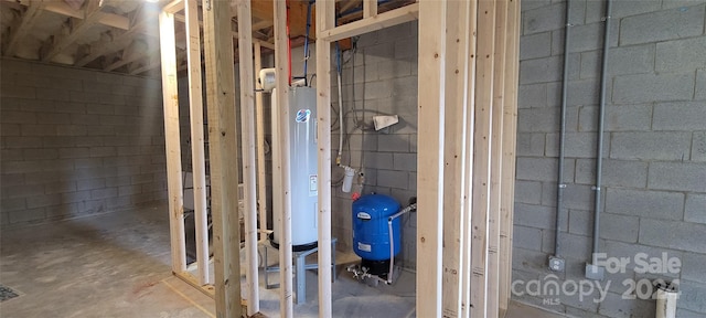 bathroom with water heater and concrete flooring