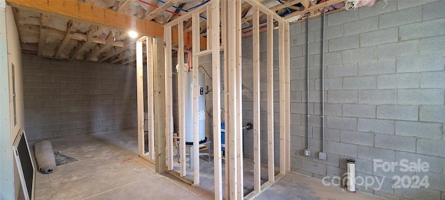 bathroom featuring water heater and concrete flooring