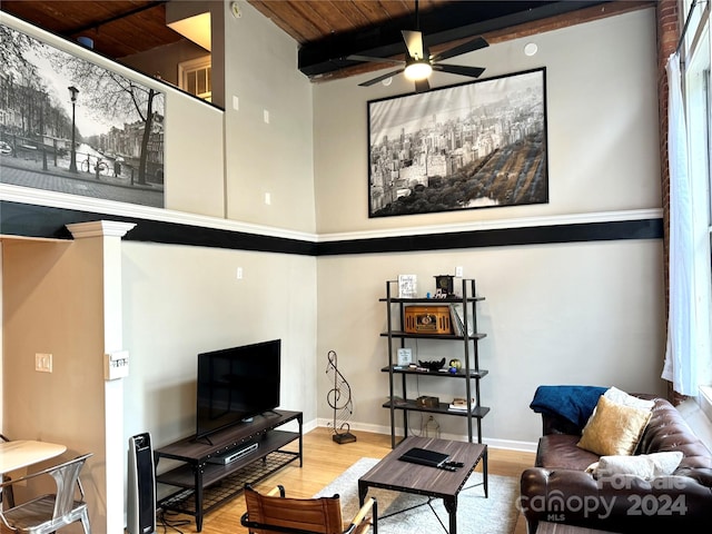 living room with beam ceiling, hardwood / wood-style floors, ceiling fan, and wooden ceiling