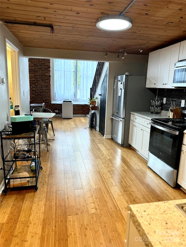 kitchen featuring white cabinets, light hardwood / wood-style flooring, and stainless steel appliances