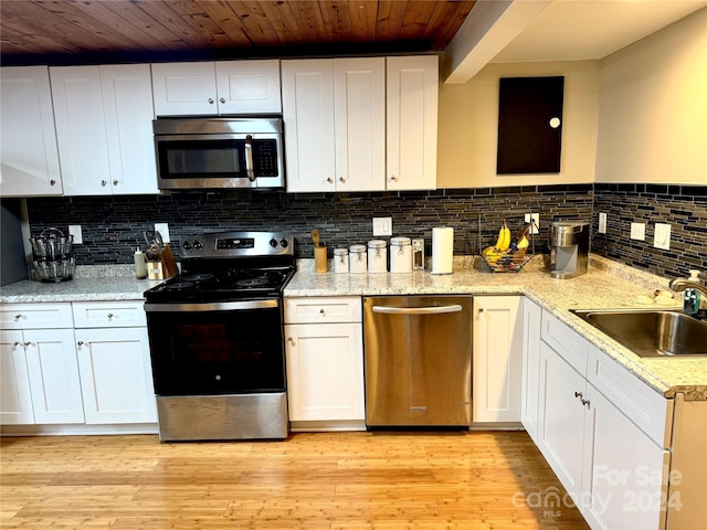 kitchen featuring sink, appliances with stainless steel finishes, and white cabinets