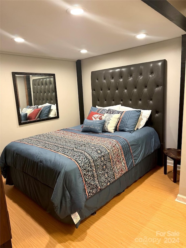 bedroom with hardwood / wood-style flooring