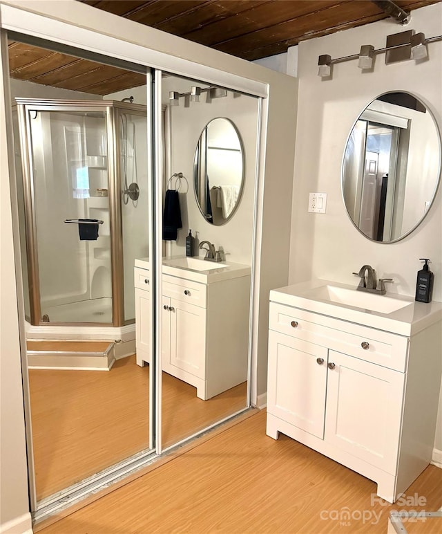 bathroom featuring a shower with door, wood ceiling, hardwood / wood-style flooring, and vanity