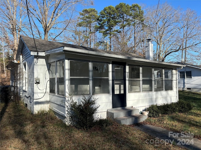 view of front of home with a sunroom