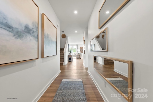 hallway with hardwood / wood-style flooring