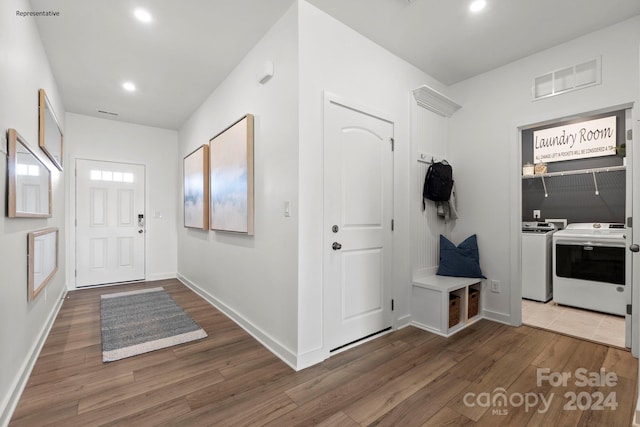 foyer entrance with dark hardwood / wood-style flooring and washer and clothes dryer