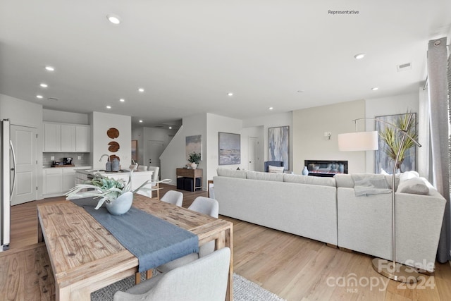 dining space with light hardwood / wood-style floors and sink