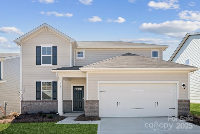 view of front facade featuring a garage, concrete driveway, and brick siding