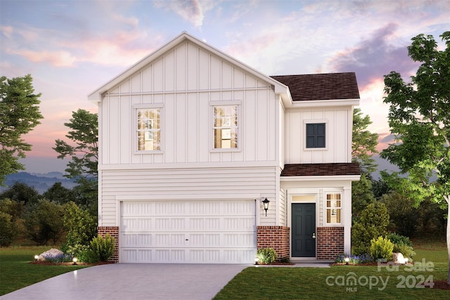 view of front of property featuring a garage and a lawn