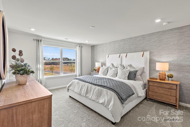 bedroom featuring baseboards, wallpapered walls, visible vents, and light colored carpet