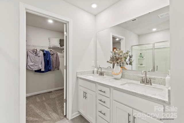 full bathroom featuring visible vents, a sink, and a shower stall