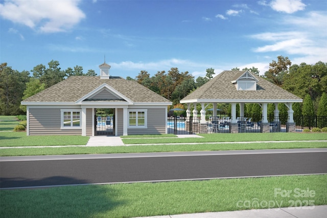 view of front of home with a gazebo, a front lawn, roof with shingles, and fence