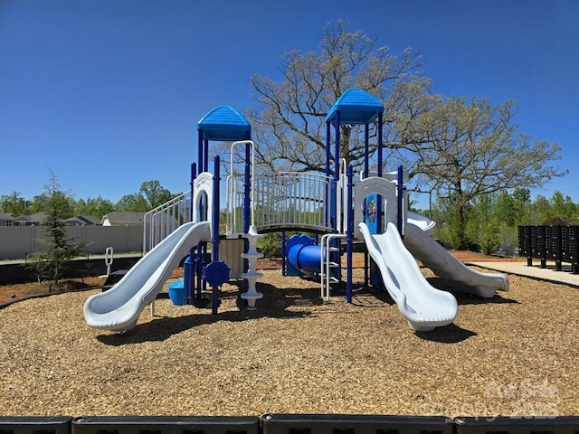 community jungle gym featuring fence