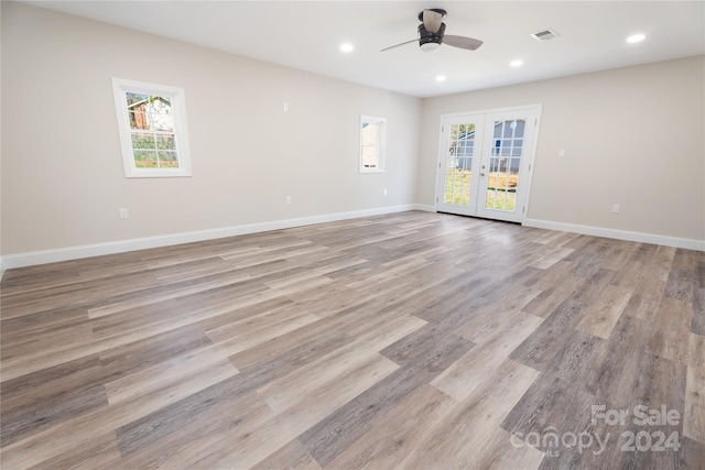 unfurnished room featuring ceiling fan, french doors, and light hardwood / wood-style flooring