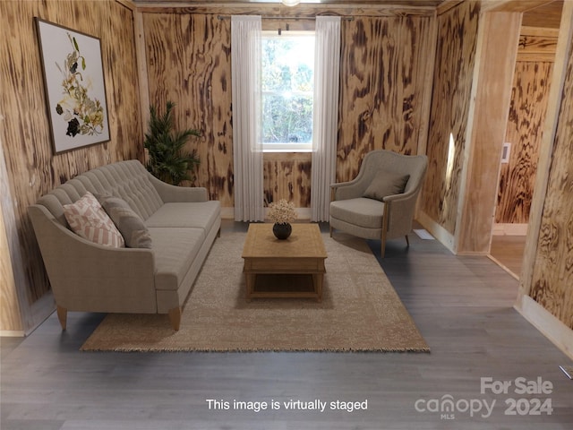 sitting room featuring wood walls and hardwood / wood-style floors