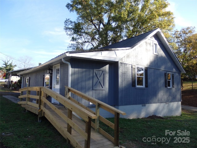 view of home's exterior with crawl space and a yard