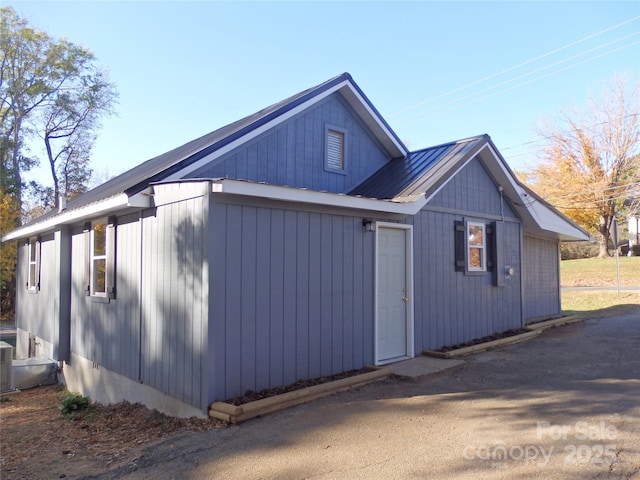 view of side of home featuring metal roof