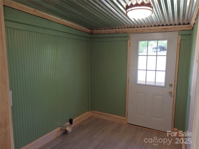 entryway with baseboards and wood finished floors
