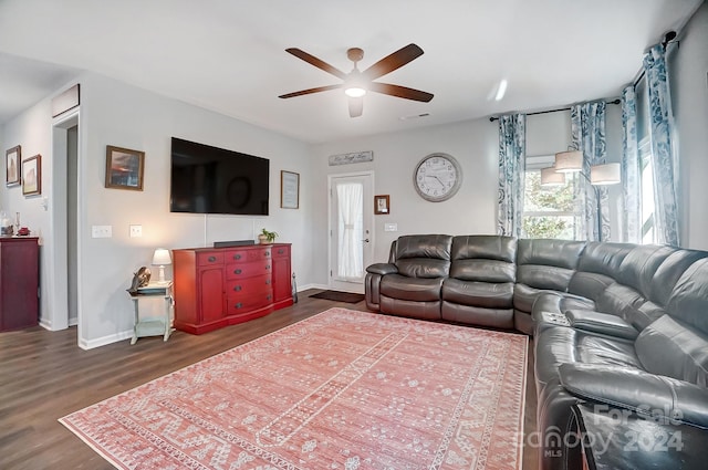 living room with dark hardwood / wood-style floors and ceiling fan