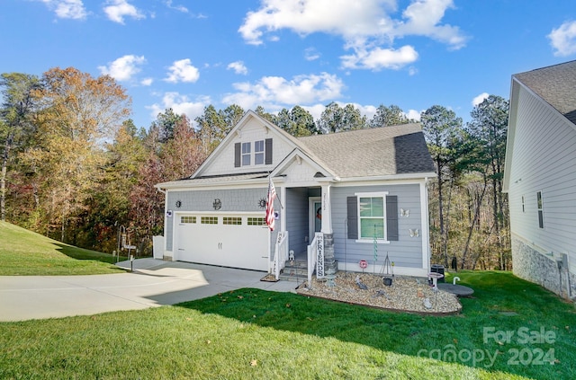 view of front of property with a garage and a front lawn