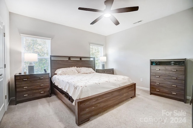 bedroom featuring light colored carpet and ceiling fan