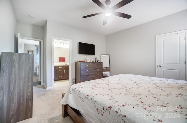 carpeted bedroom featuring ceiling fan and ensuite bathroom