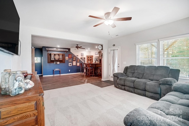 living room with hardwood / wood-style flooring and ceiling fan