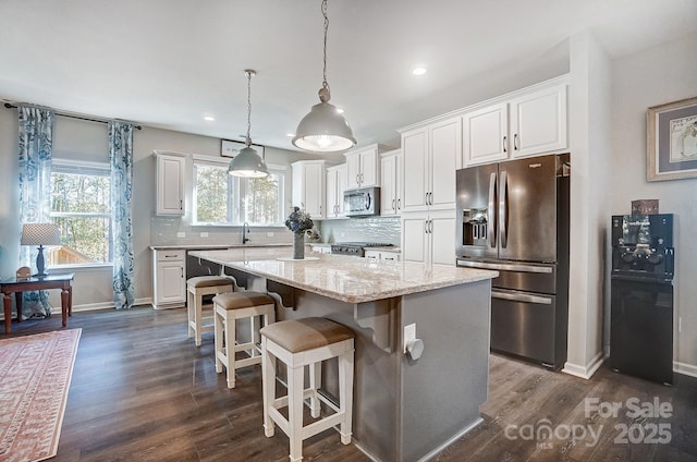 25622 Seagull Dr Unit 645, Lancaster, SC 29720 - kitchen with appliances with stainless steel finishes, a kitchen island, white cabinets, decorative backsplash, and recessed lighting