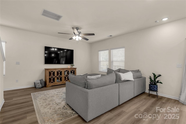 living room with ceiling fan and hardwood / wood-style floors