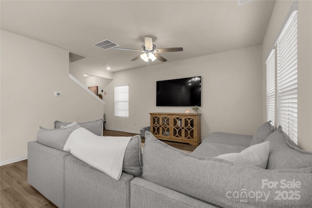 living room featuring wood-type flooring and ceiling fan