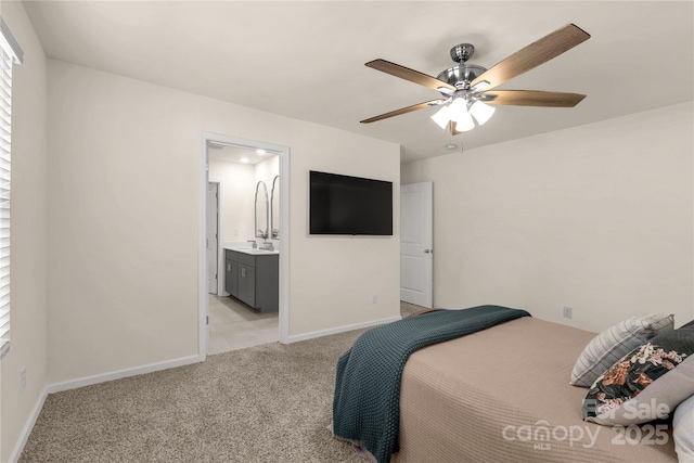 carpeted bedroom with ensuite bath and ceiling fan