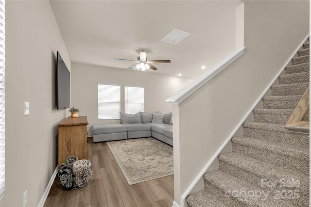 living room with hardwood / wood-style flooring and ceiling fan