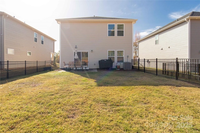 rear view of property featuring a lawn