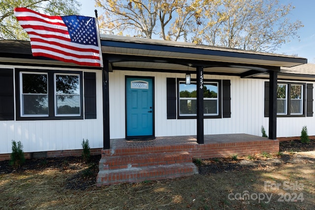 doorway to property with a porch