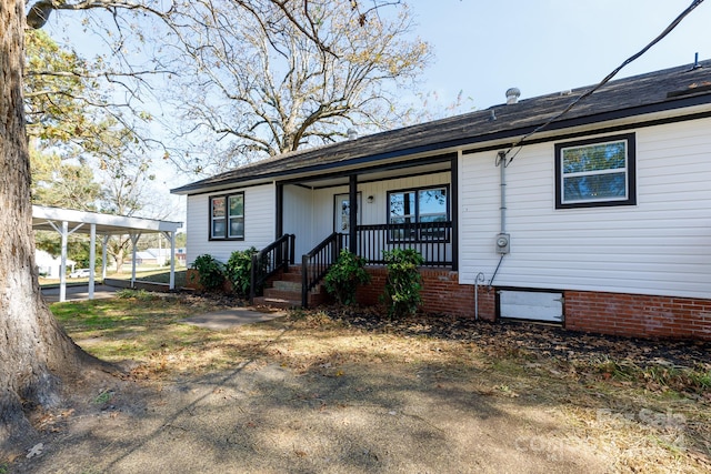 single story home with a carport and covered porch